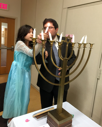 Rabbi Siff and his daughter lit the NHS menorah.