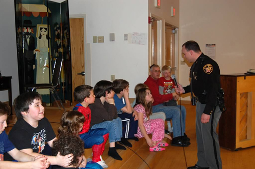 A policeman taught the kids some self-defense moves.