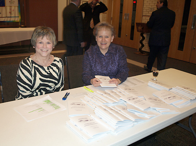 Karyn Lazear and Gail Stern registered guests in the NHS lobby.